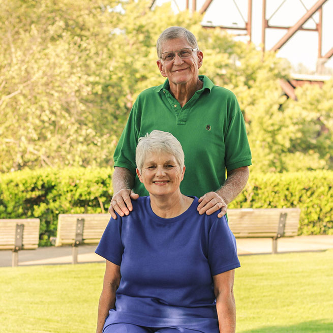 Photo of Melinda McKnight and her husband in a park setting