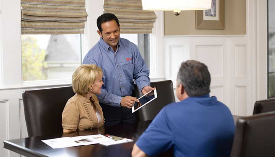 Home service expert explaining project on digital device