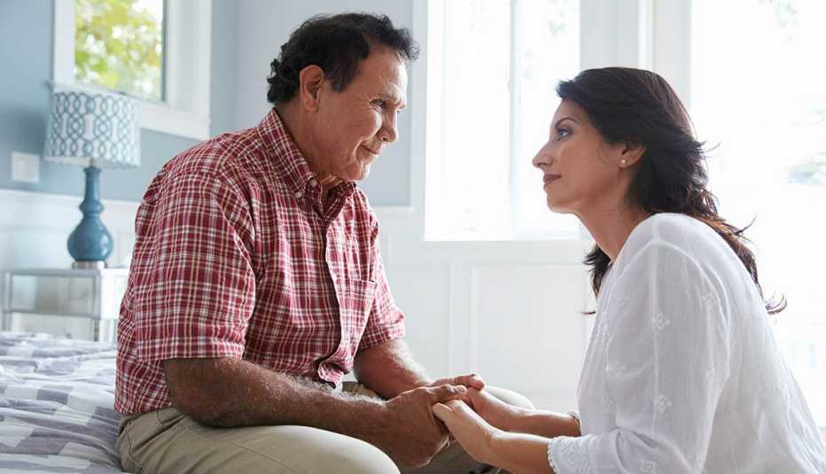Adult Daughter Comforting Father Suffering With Dementia