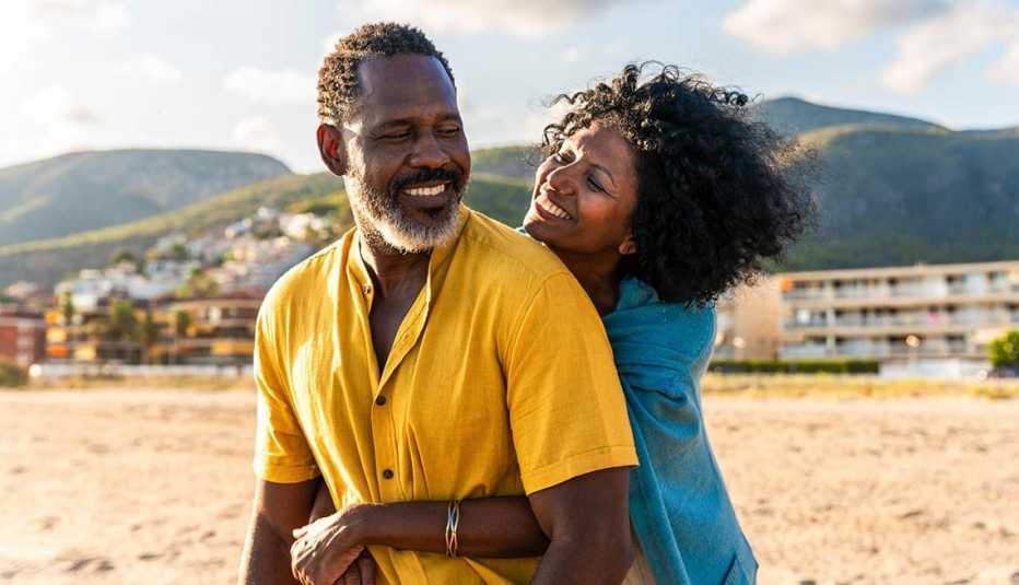 Happy couple sharing a tender moment by the sea