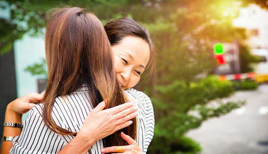 A woman hugging her daugher