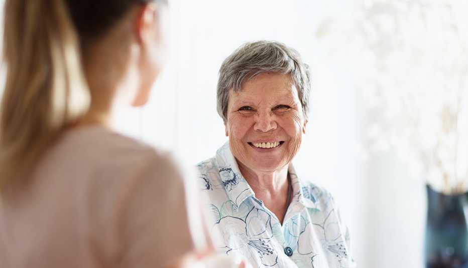 young female caregiver with an older woman