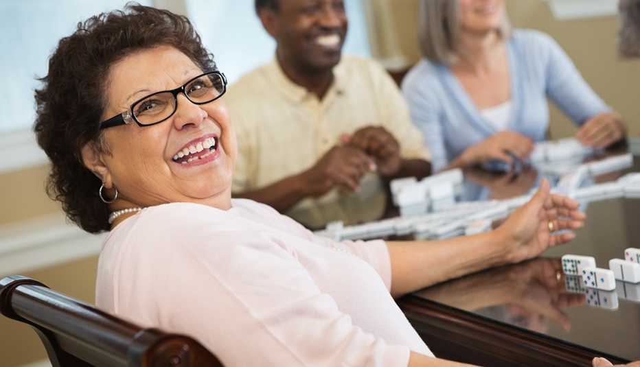 Woman playing dominoes with friends at her retirement community Woman playing dominoes with friends at her retirement community