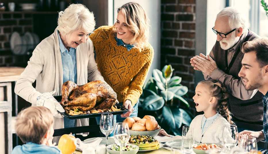 grandmother carrying turkey for family dinner