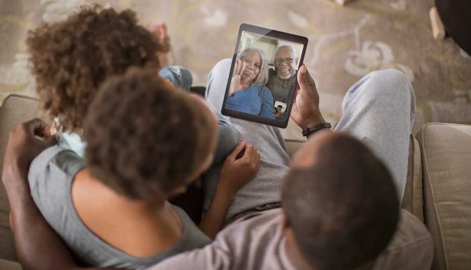 A family having a video call with their older parents