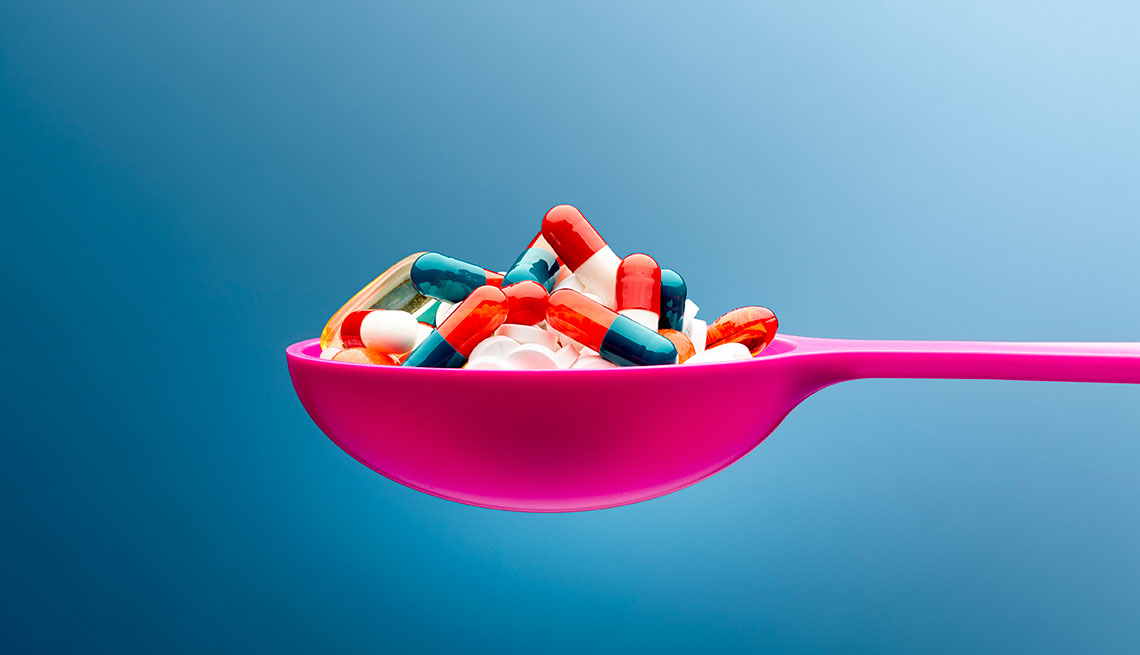 Pills on a pink spoon