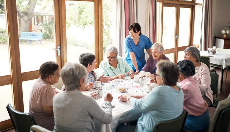 A group of women playing cards together at an assisted living home A group of women playing cards together at an assisted living home