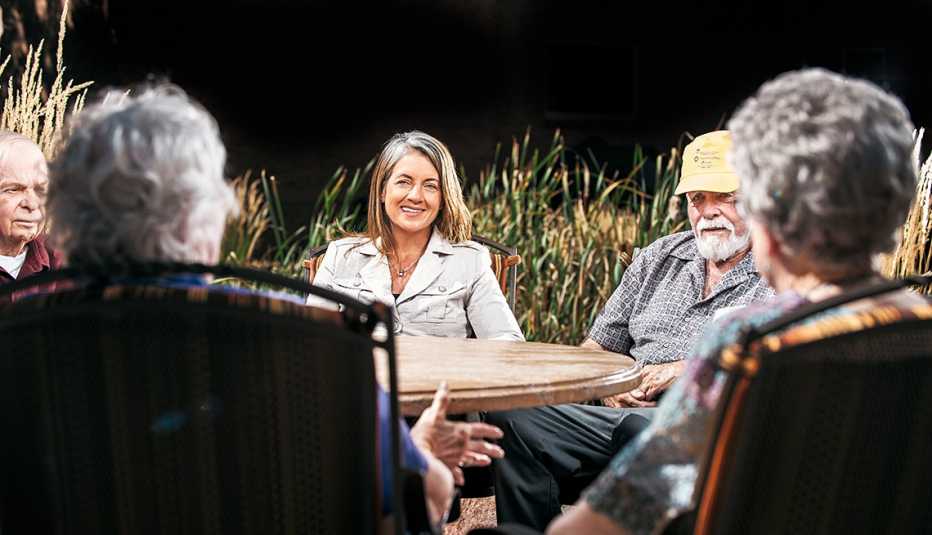 Senior living expert Jill Vitale-Aussem sitting at a table with older adults
