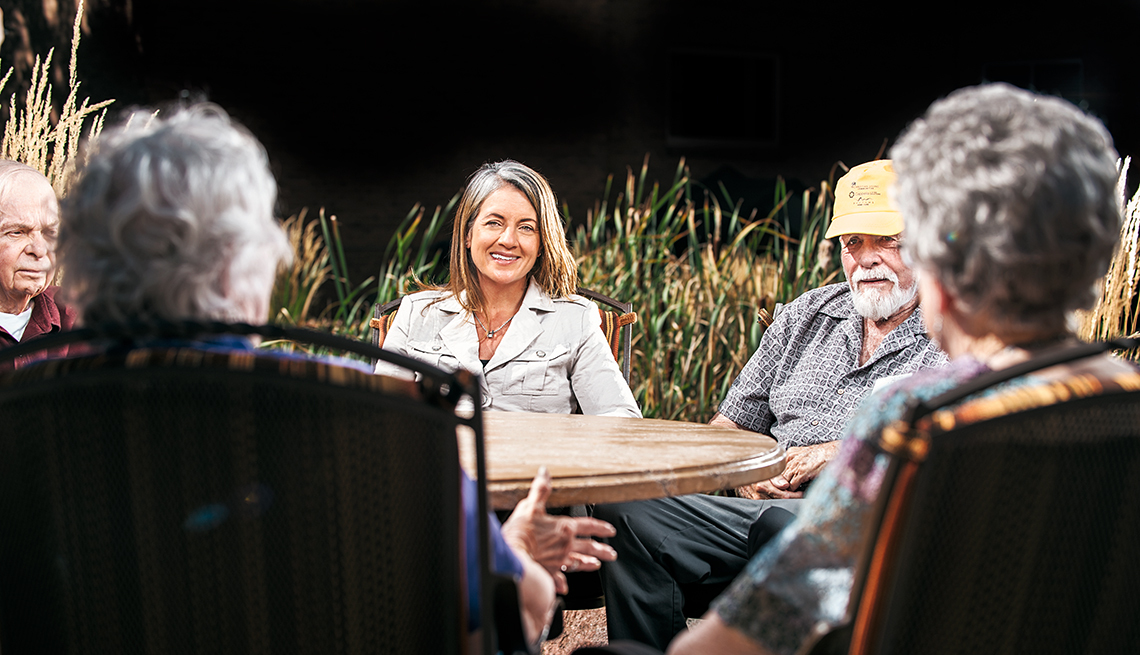 Senior living expert Jill Vitale-Aussem sitting at a table with older adults