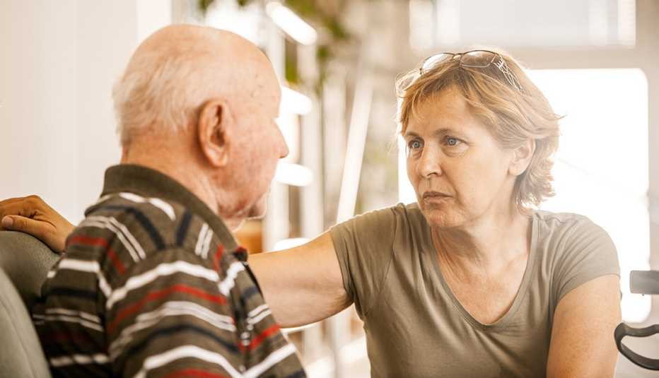 Adult daughter having a serious discussion with her father at home