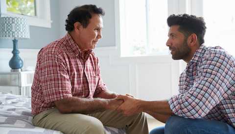 Son comforting adult father