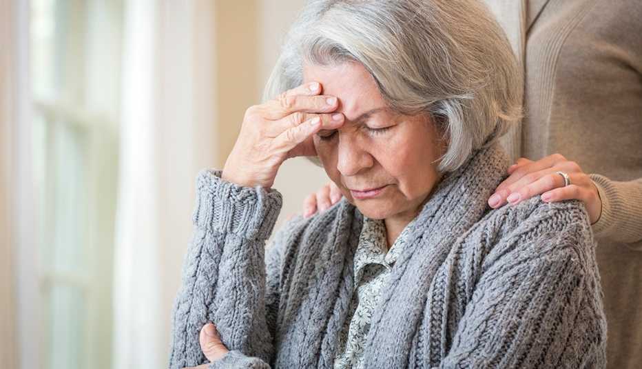 close up of daughter comforting pained mother 