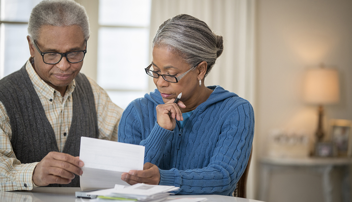 A couple looking through retirement planning paperwork