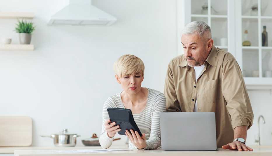 woman and man discuss finances in kitchen