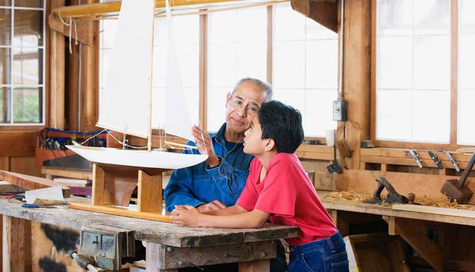 Grandson and grandfather building a boat