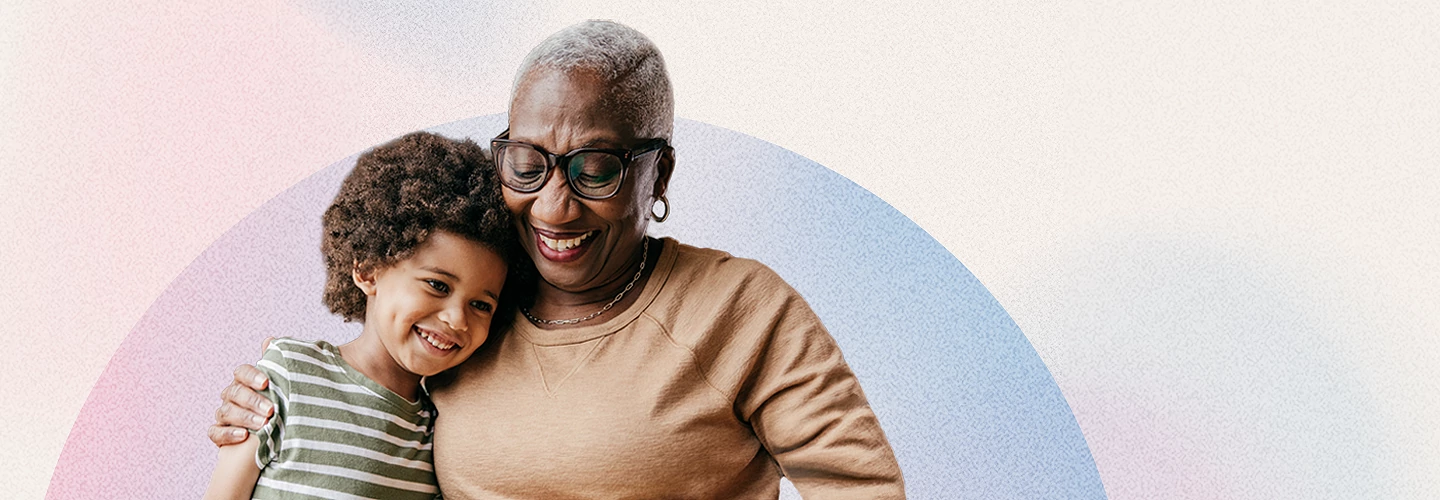 A grandparent hugs her grandchild