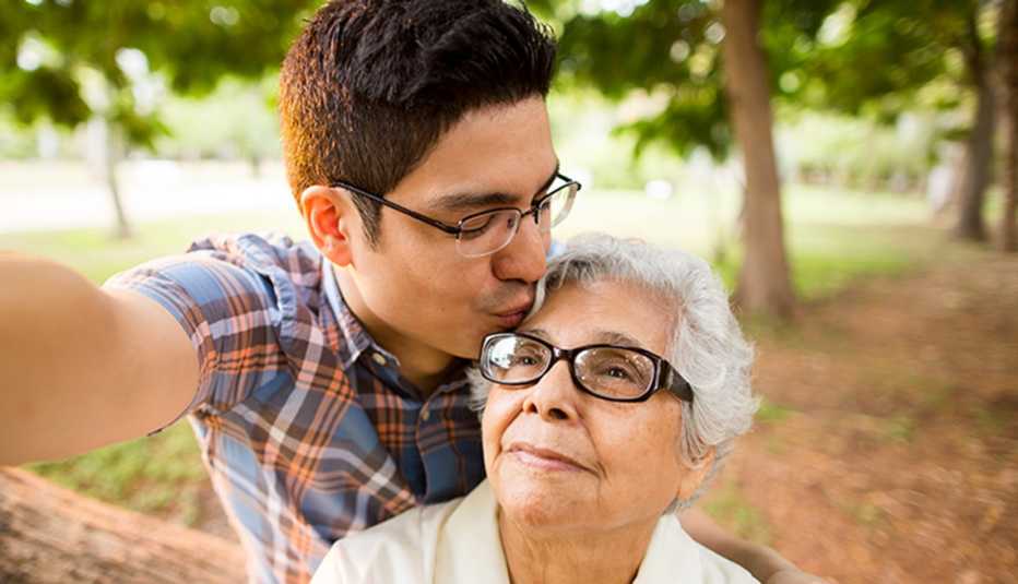 Grandson and grandmother kissing forehead