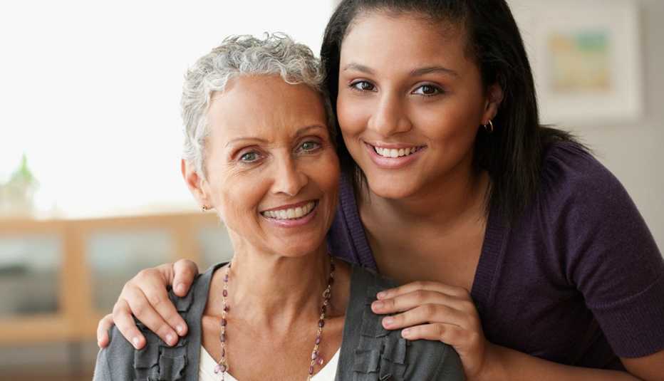 an adult child hugs her mother 