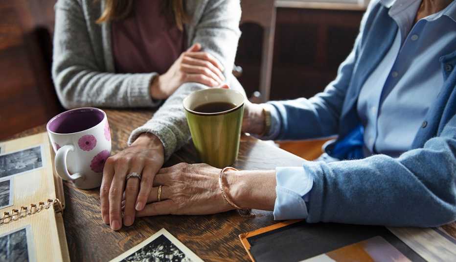 Mother and daughter hands at a table
