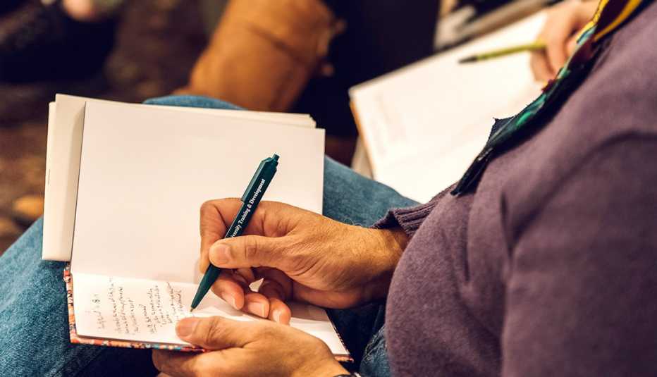 Attendee Michael Smith participates in a journaling exercise during the Caring for the Caregiver retreat held at Rockwood Manor in Potomac, Maryland. 