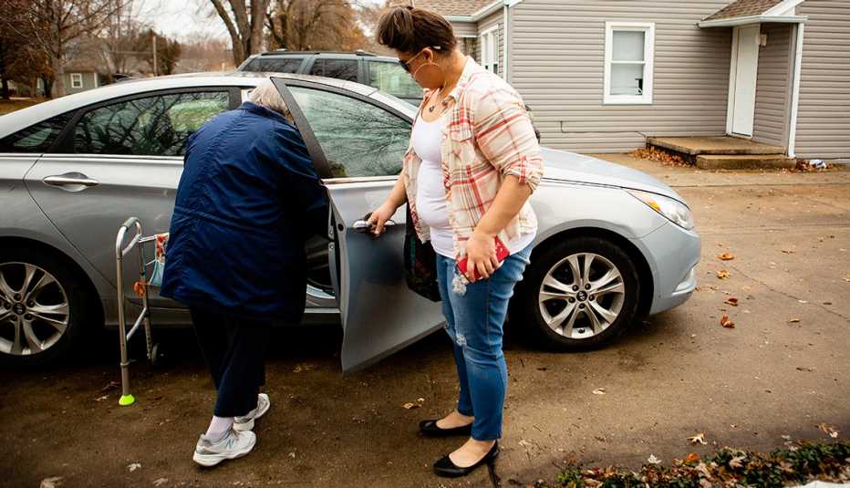 Rachel Hiles helping her grandmother into the car Rachel Hiles helping her grandmother into the car