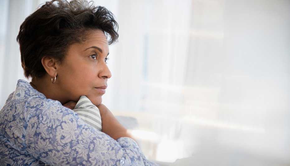 Anxious looking woman looking out a window