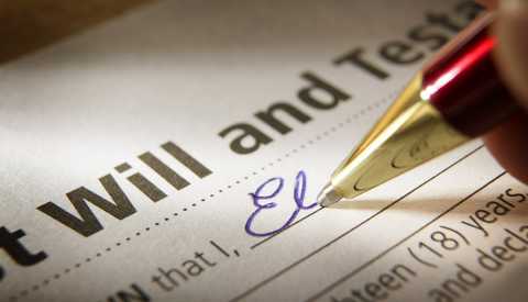 closeup of the signing of a last will and testament with a red and gold ballpoint pen writing in blue ink closeup of the signing of a last will and testament with a red and gold ballpoint pen writing in blue ink