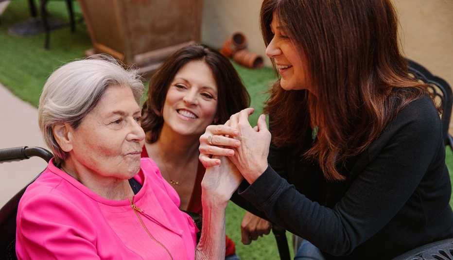 Comedian Sue Ball (right) works with Muriel Klein (left), an Alzheimer's patient, through a program called Laughter on Call at Silverado Beverly Place in Los Angeles, California February 17, 2018. Muriel's daughter Dani Klein Modisett (center) joins in