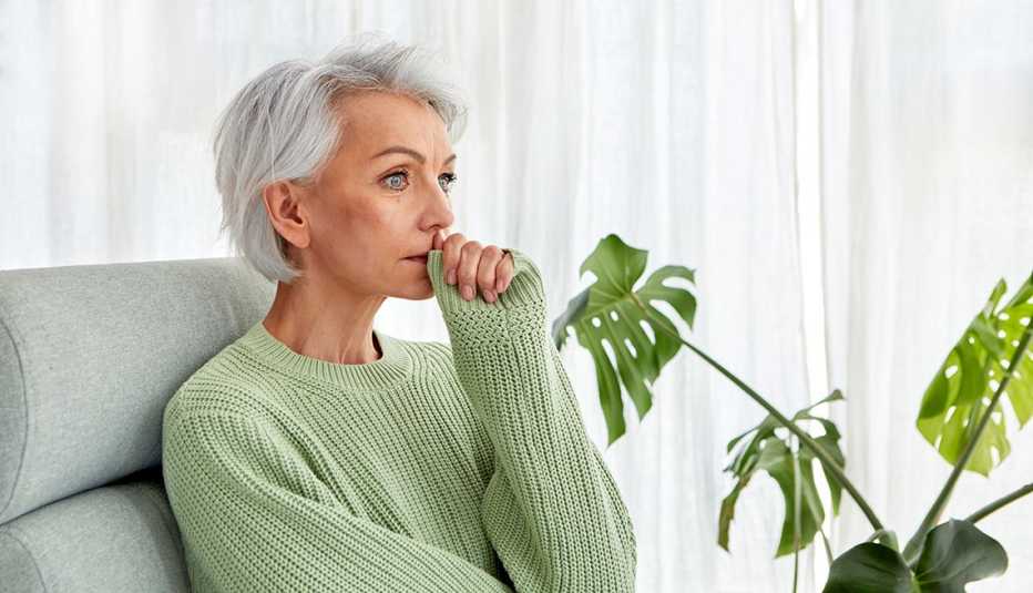 woman sitting on a chair thinking deeply
