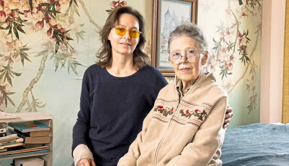janet lenius sitting with her mother germaine bruins in her mothers bedroom