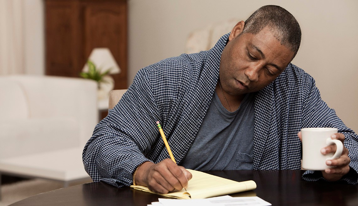 African American Man Writing Down His Health History, Recording Your Health History
