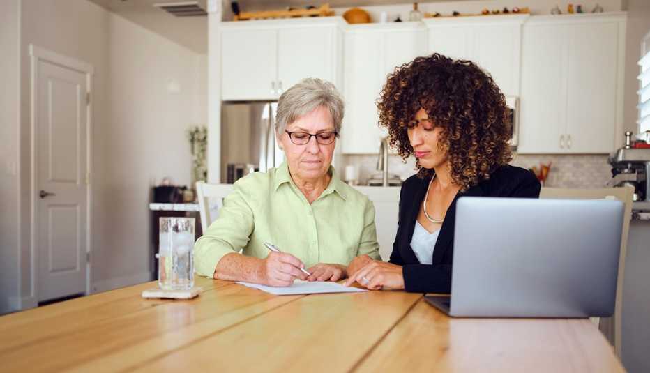 A woman filling out paperwork with a family member.