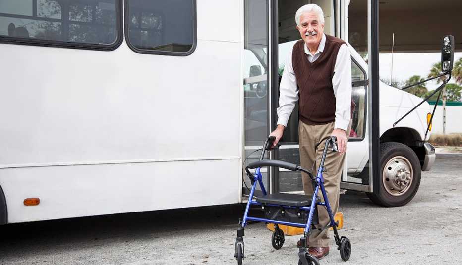 Man using a walker getting into a public transportation van 
