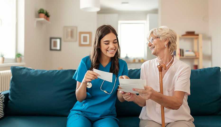 woman sitting with nursing home staff member
