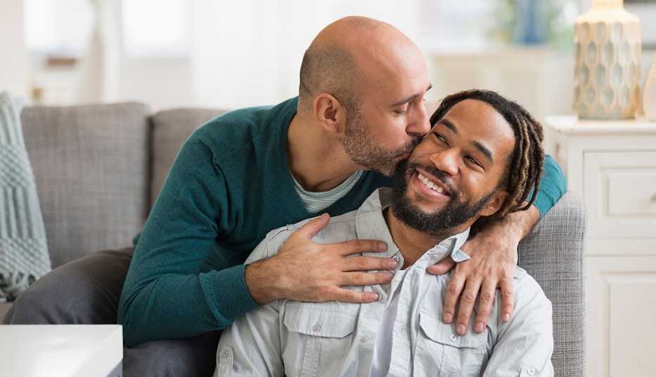 man kissing his partner at home