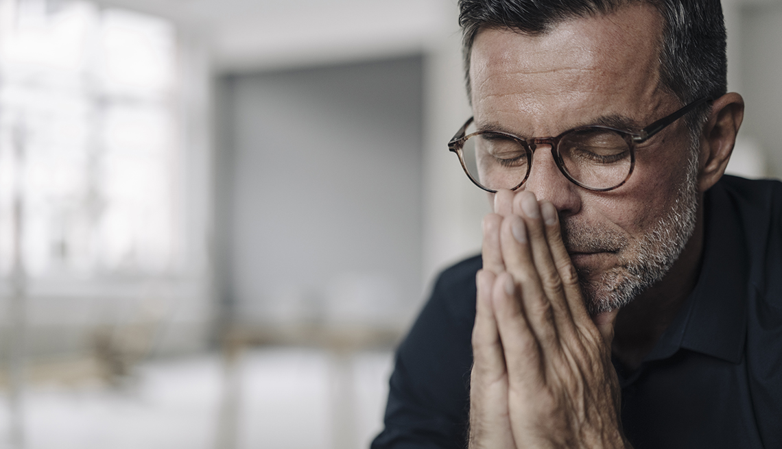 a stressed looking male family caregiver