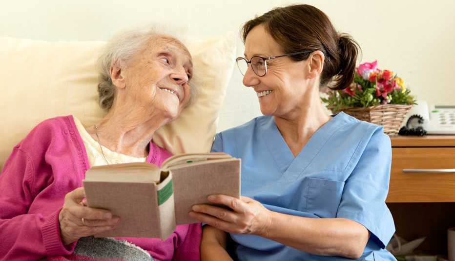 Daughter reading a book to her mother Daughter reading a book to her mother