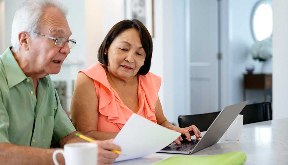 a couple looking through their finances making a budget for long term care expenses