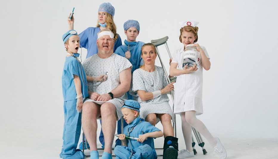 Jeannie and Jim Gaffigan dressed in medical gowns with their five children all dressed up as doctors and nurses
