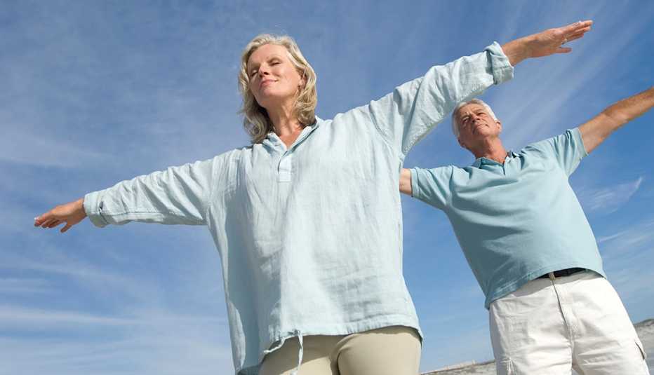a couple doing yoga tohelp with stress
