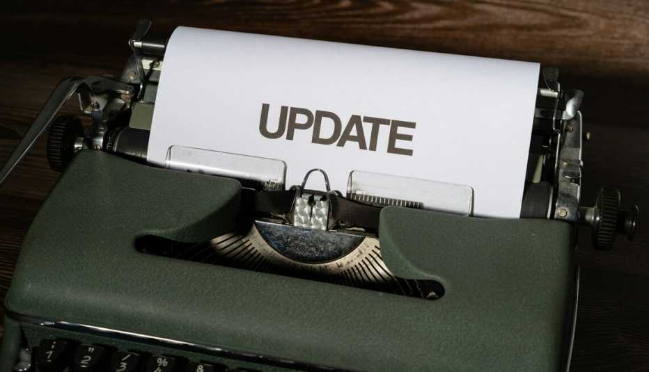 Typewriter with a peace of paper coming out of it with the words update on it. 