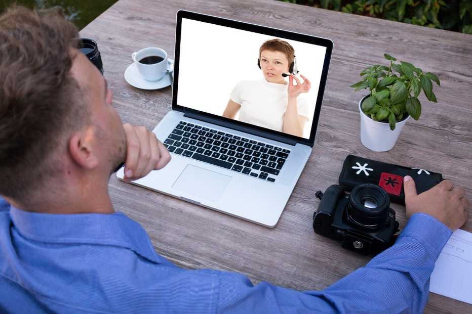 Man viewing an online training on a laptop at his desk