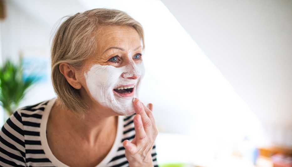 A woman applying face cream A woman applying face cream