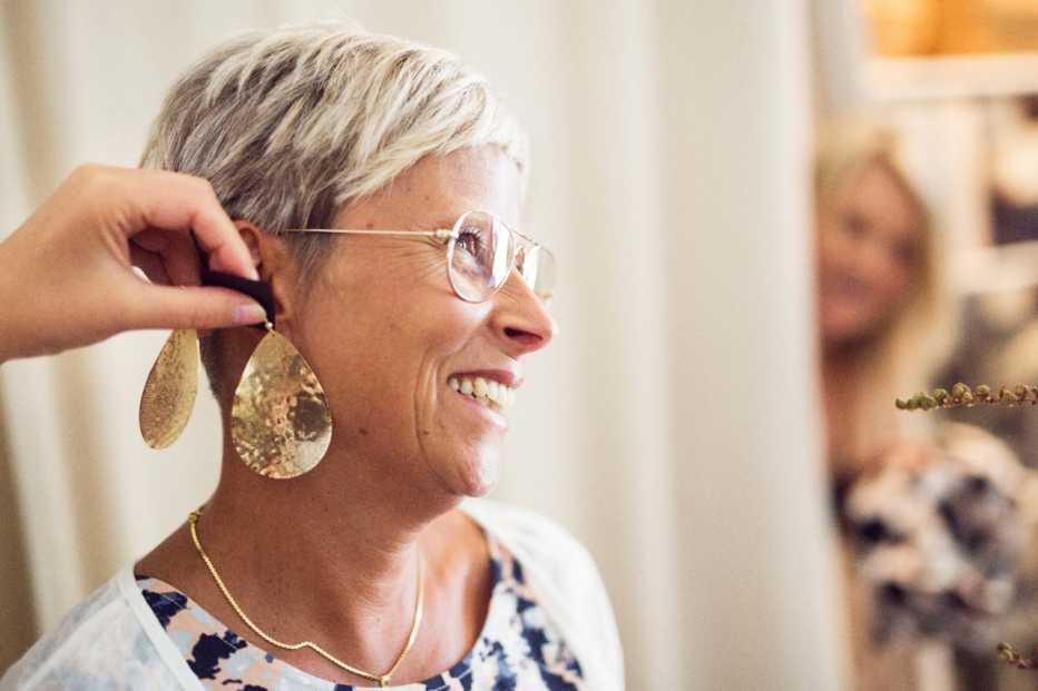 Woman trying earrings