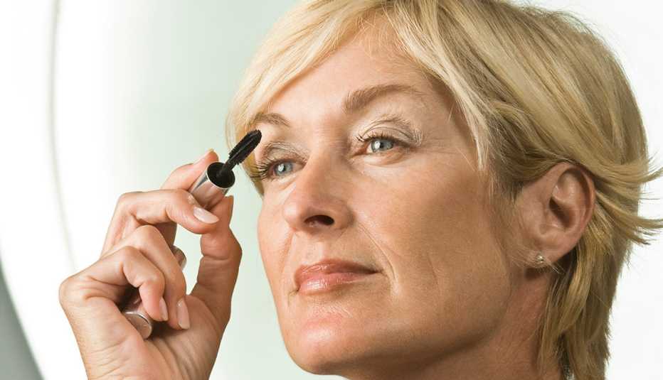 Woman applying mascara