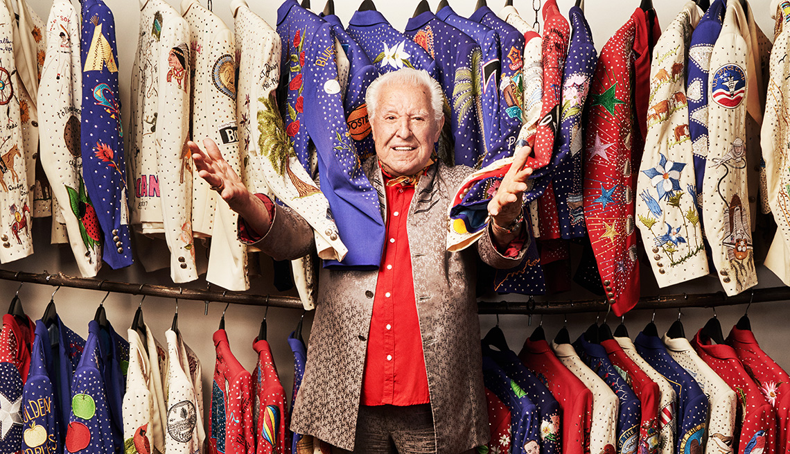 Manuel Cuevas standing in front of clothes