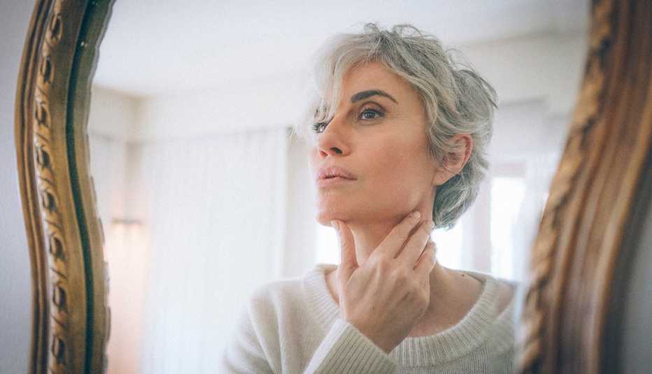 A woman looking at herself in the mirror