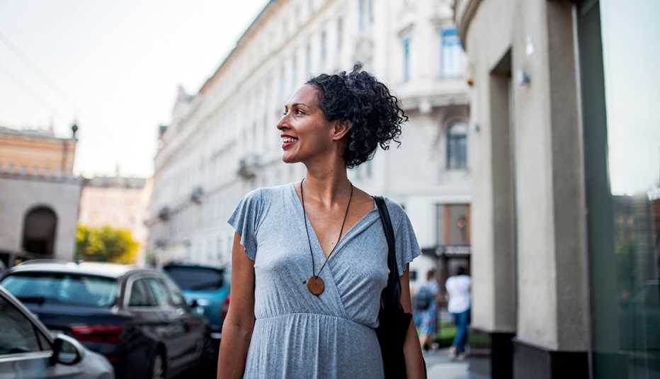 A woman in a blue dress walking around on the streets