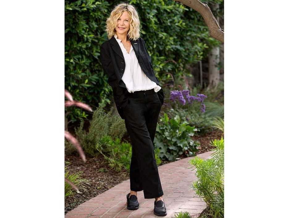 Meg Ryan wearing a black pant suit.