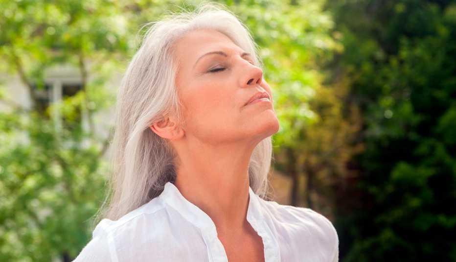 Woman enjoying the fresh air outdoors Woman enjoying the fresh air outdoors